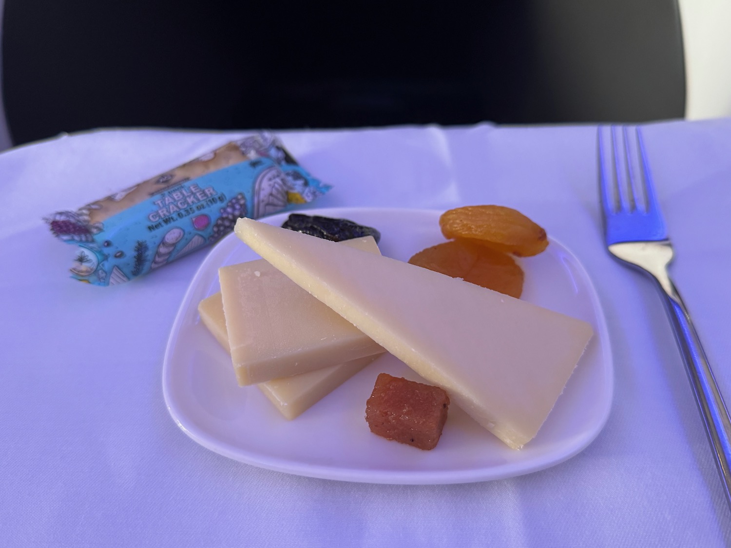 a plate of cheese and dried fruit