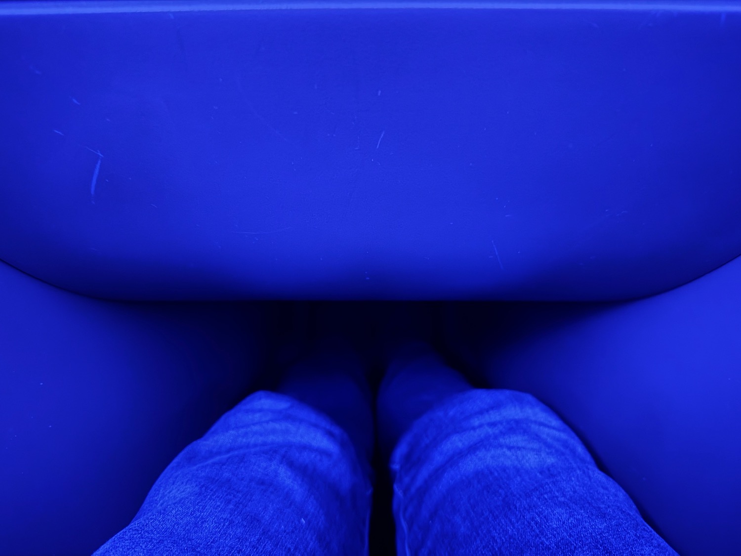 a blue chair with legs and a blue chair