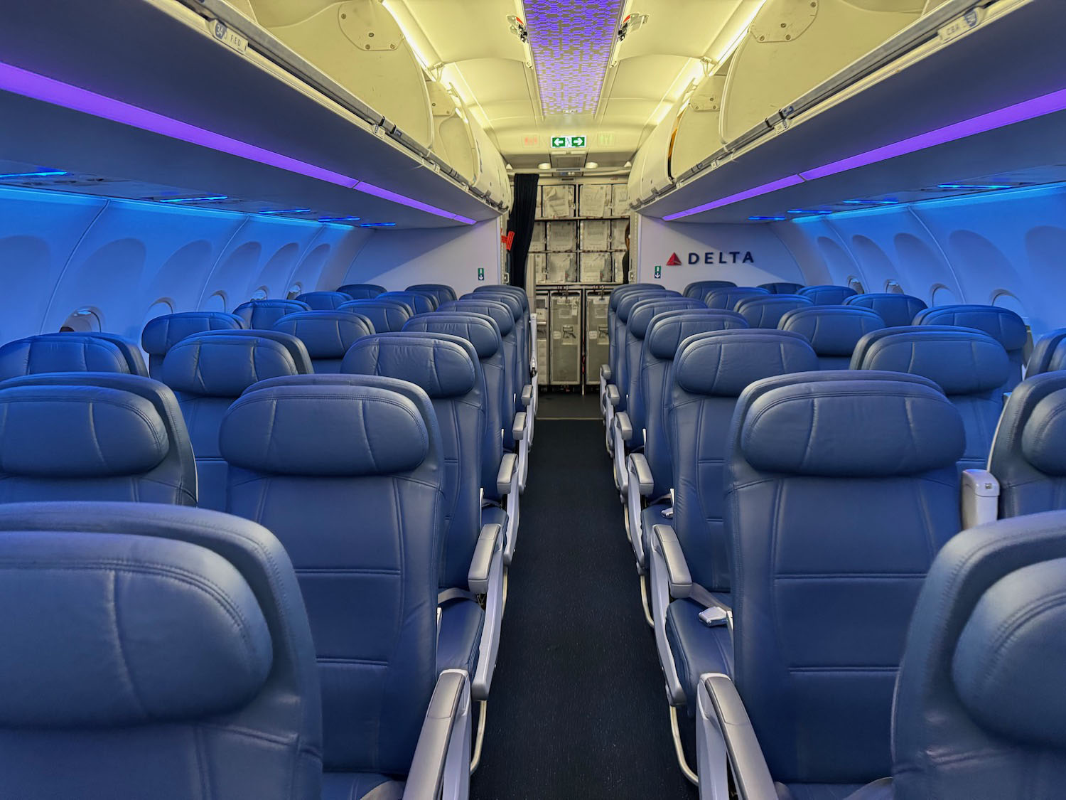 the inside of an airplane with blue seats