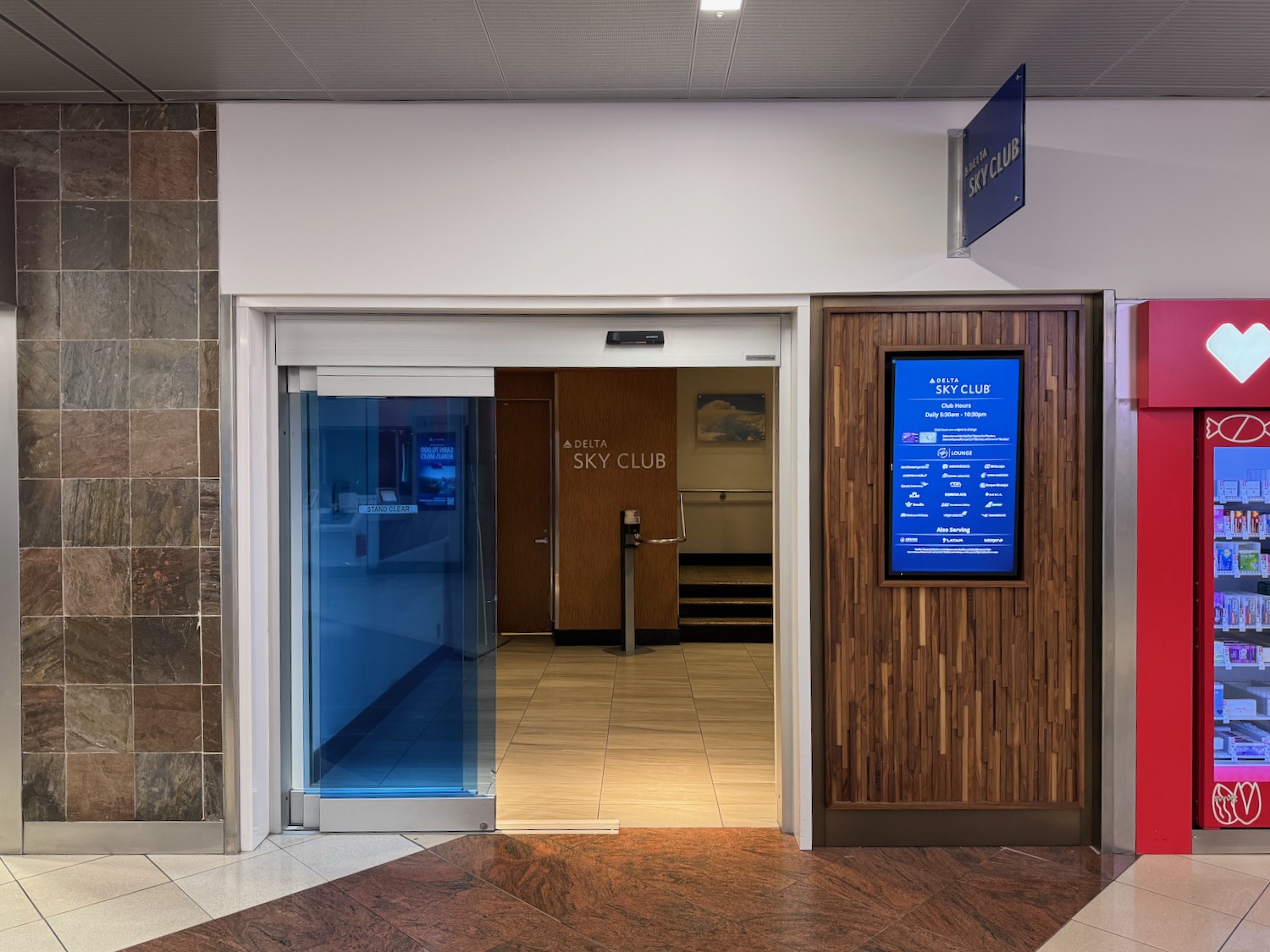 a glass door with a sign in front of a building