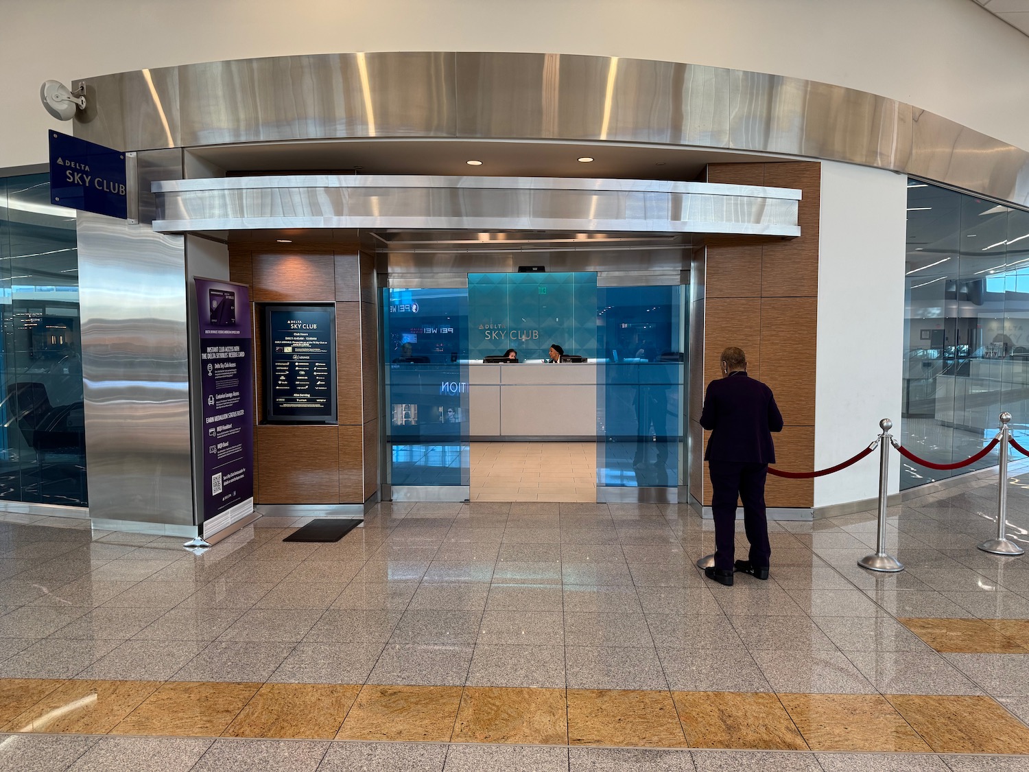 a man standing in front of a glass door