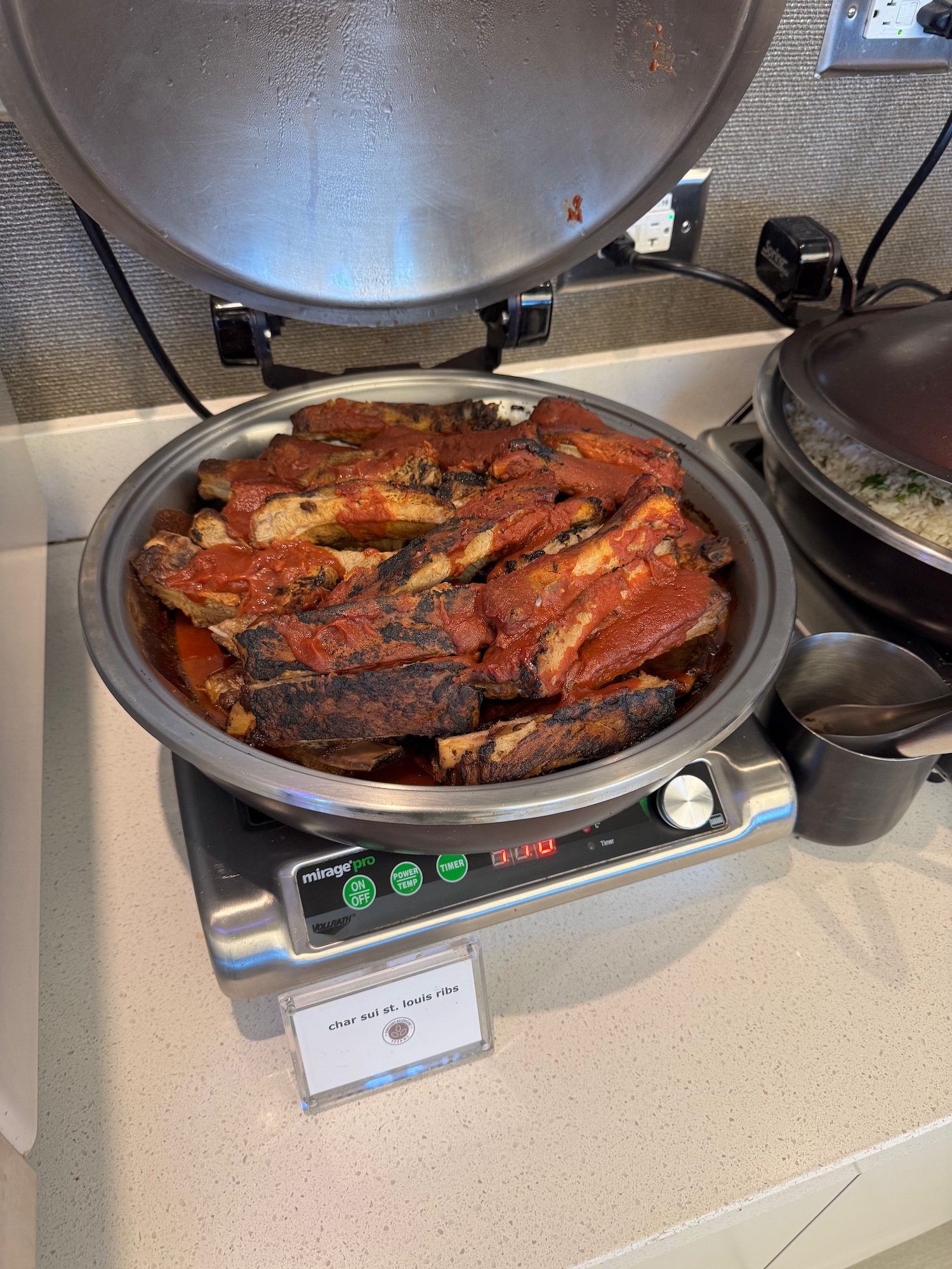 a plate of ribs in sauce on a scale