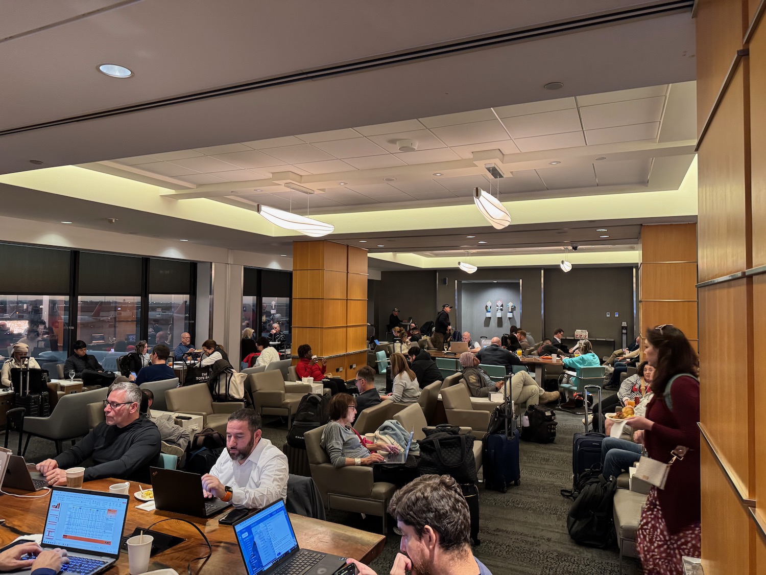 a group of people sitting in a room with laptops