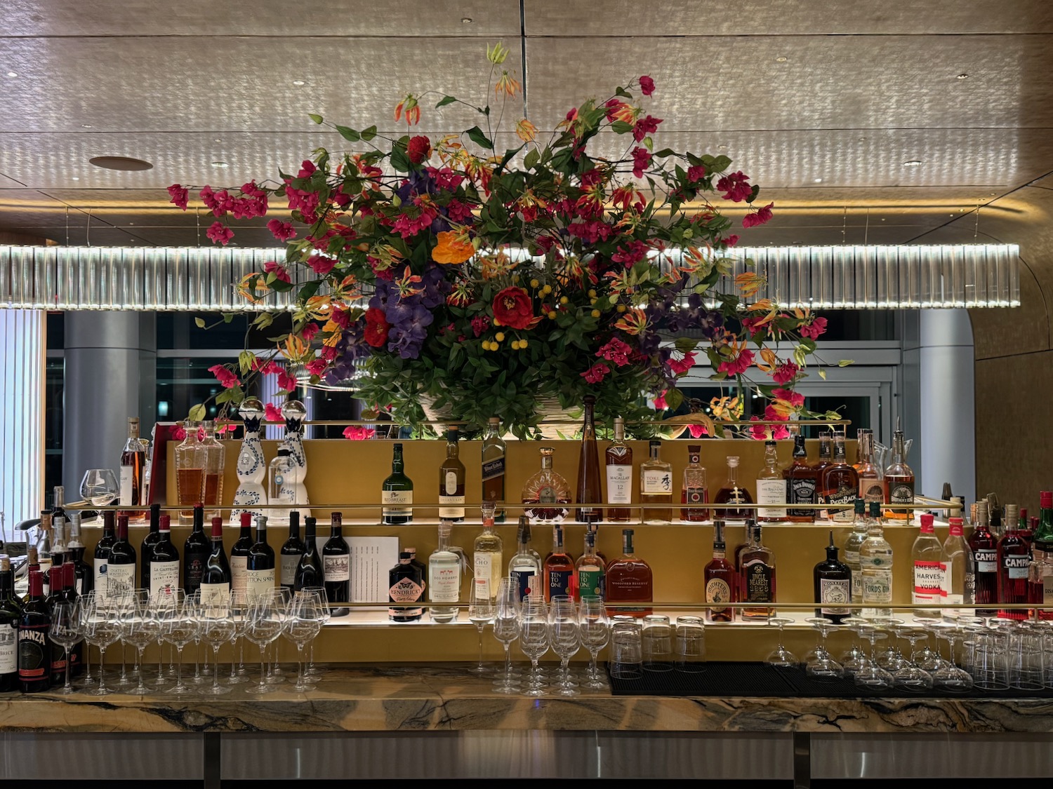 a bar with bottles of alcohol and flowers