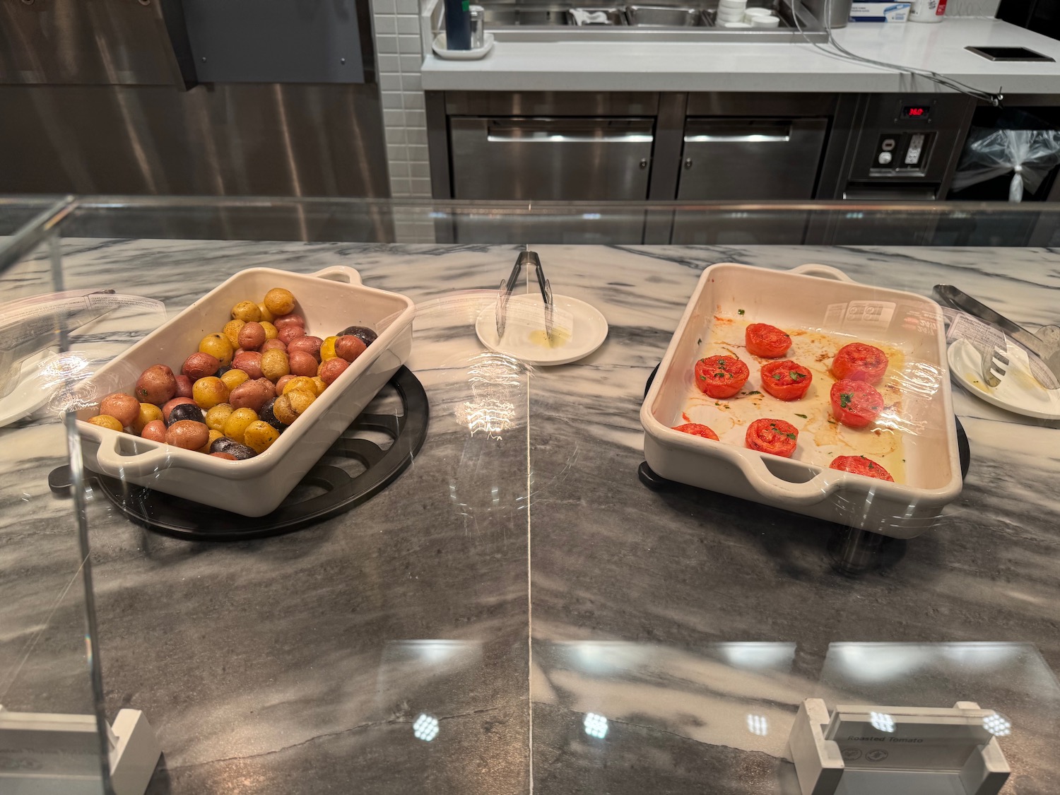 a couple of white baking pans with food in them