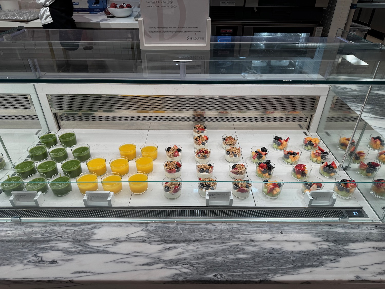 a display case with different colored drinks