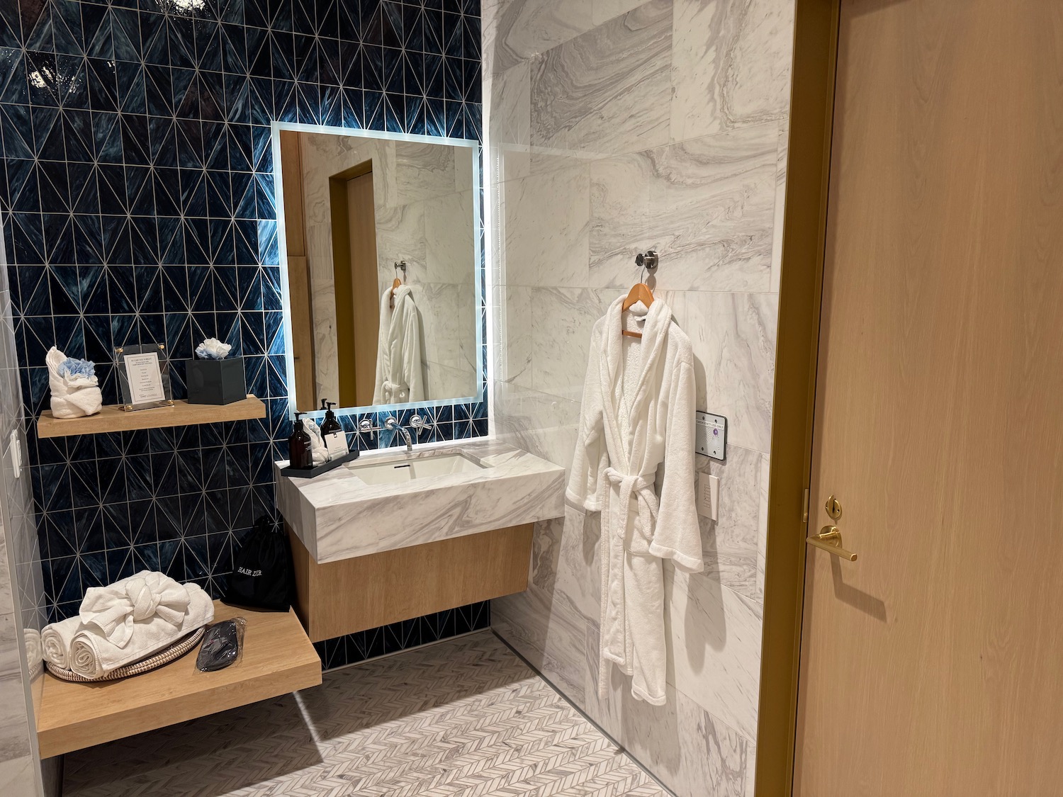 a bathroom with a white robe and sink