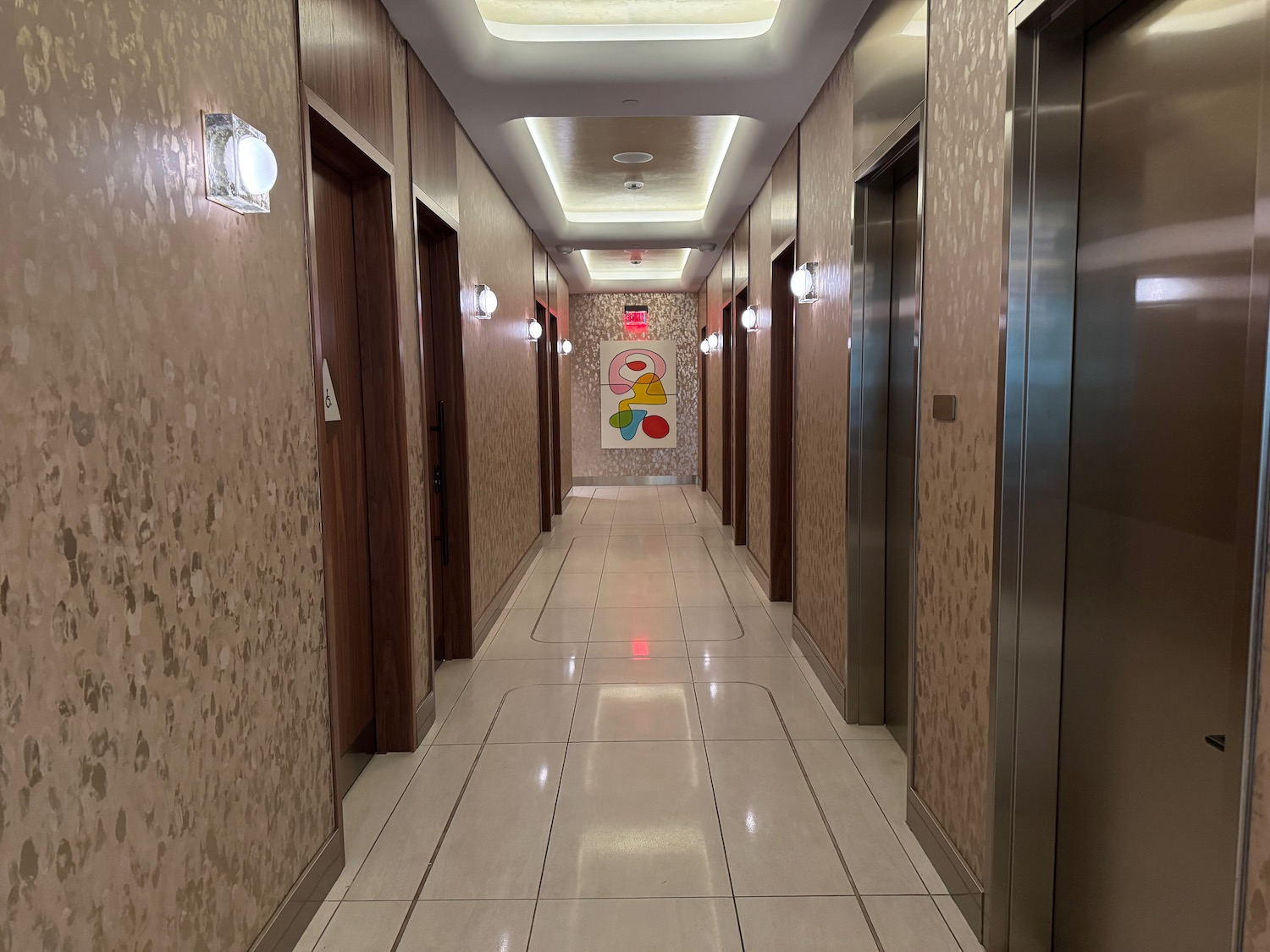 a hallway with elevators and lights