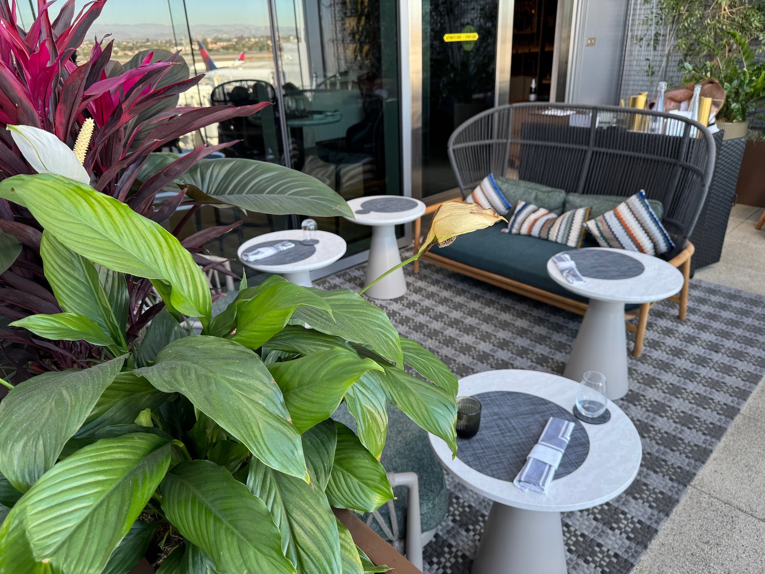 a patio with tables and chairs