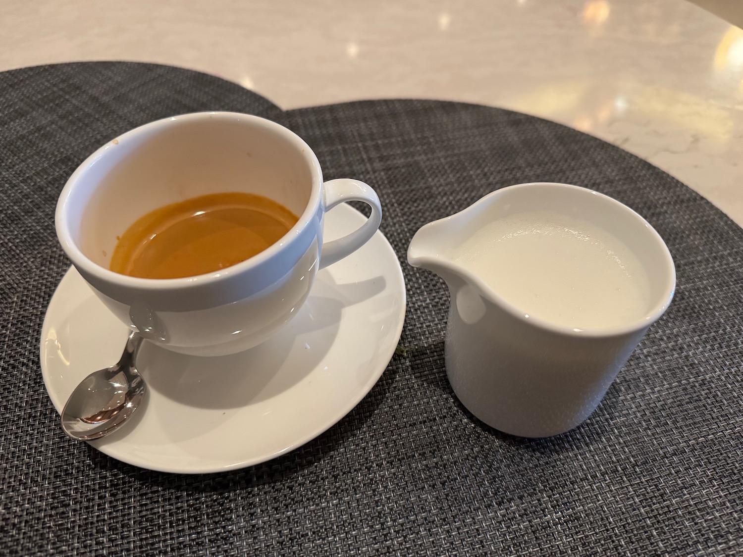 a cup of coffee and a saucer with a spoon