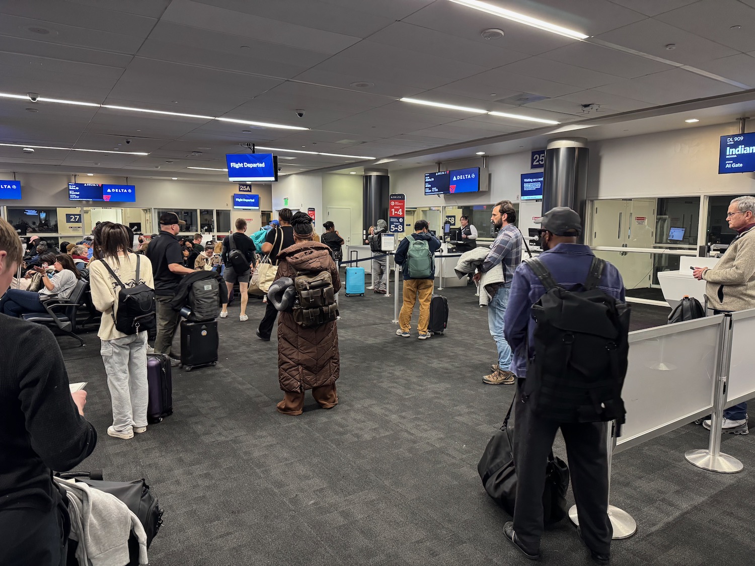 a group of people standing in a line in an airport