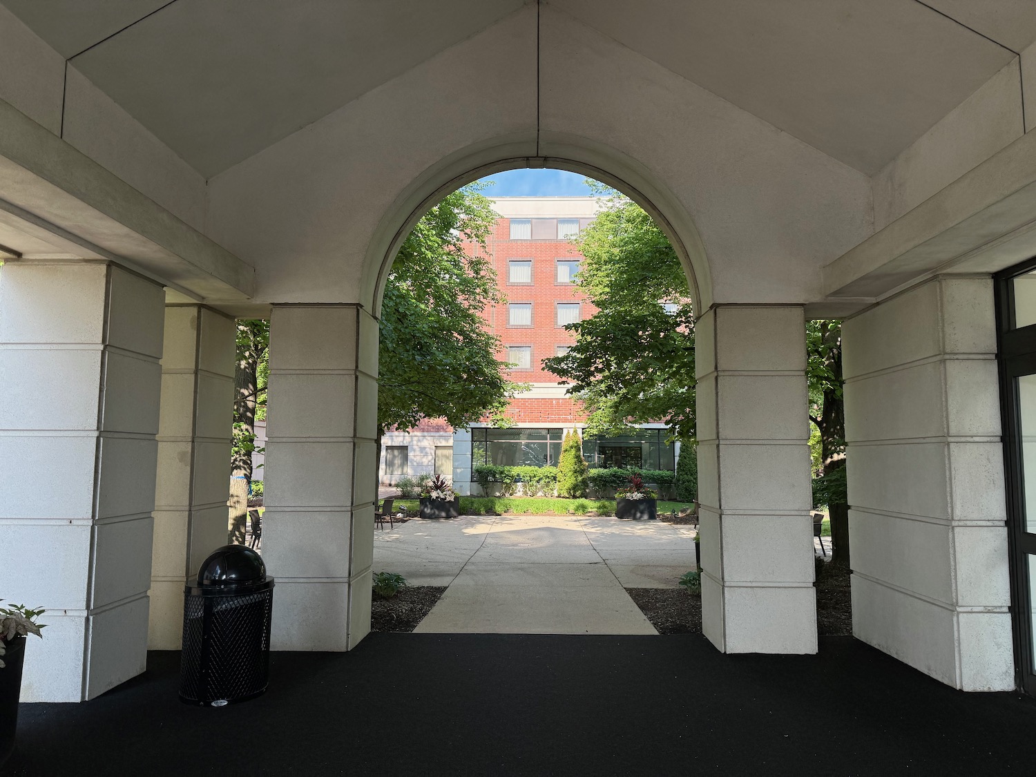 a building with trees and a building in the background