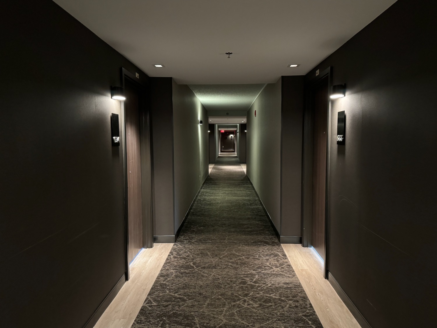 a hallway with dark walls and lights