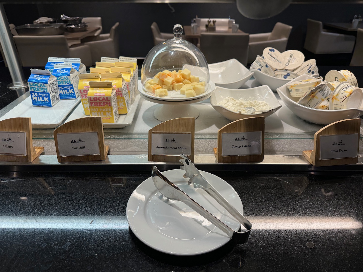 a table with plates of cheese and butter