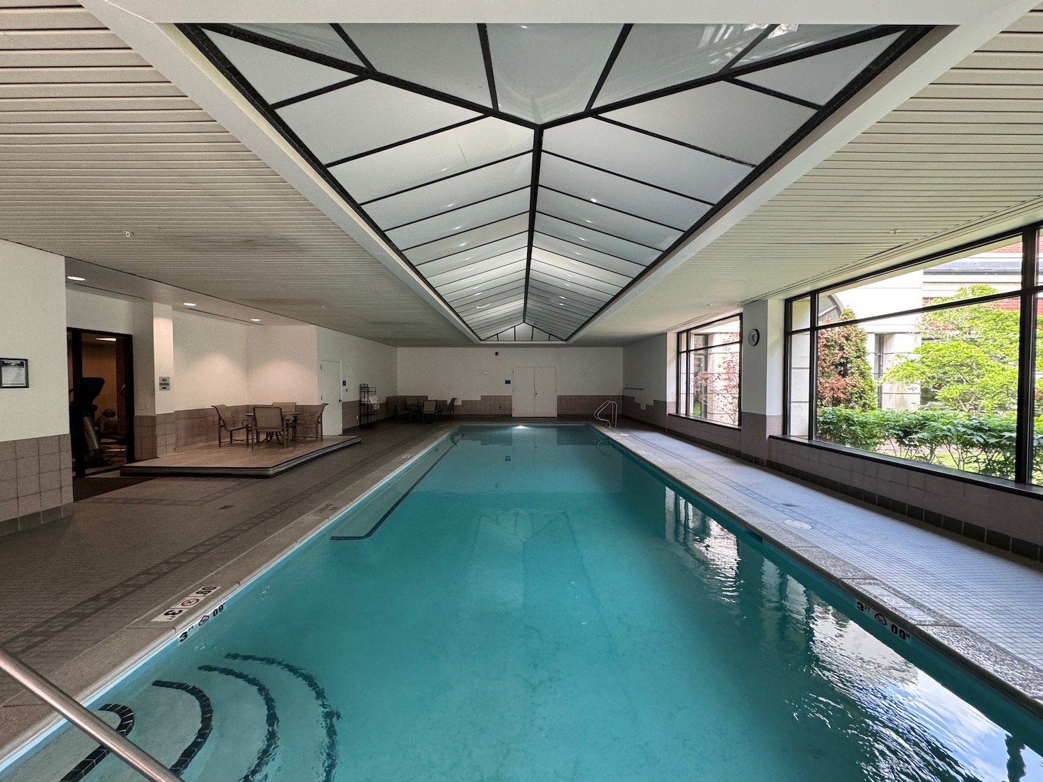 a indoor swimming pool with a large white ceiling