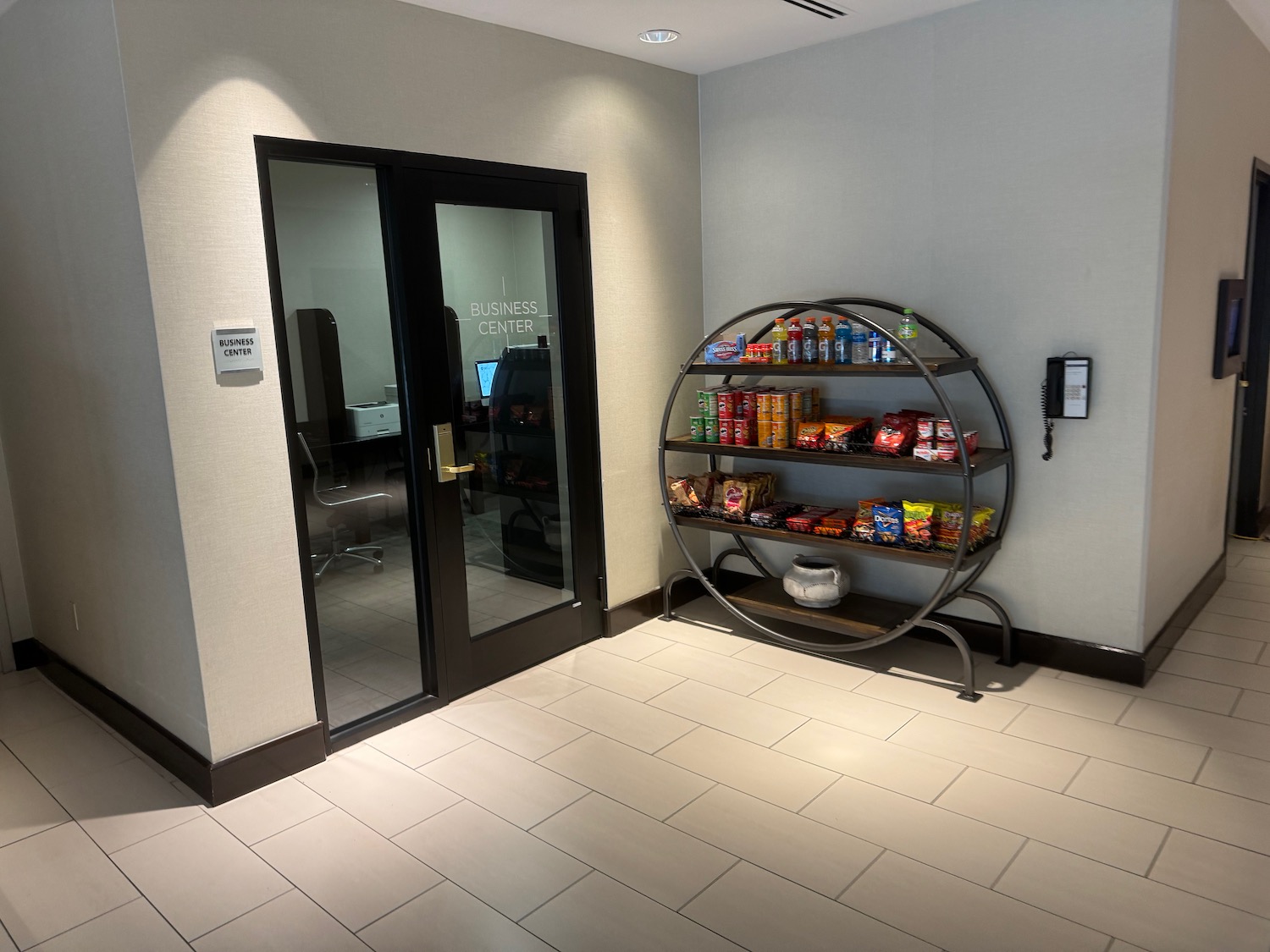 a room with a glass door and a shelf with snacks