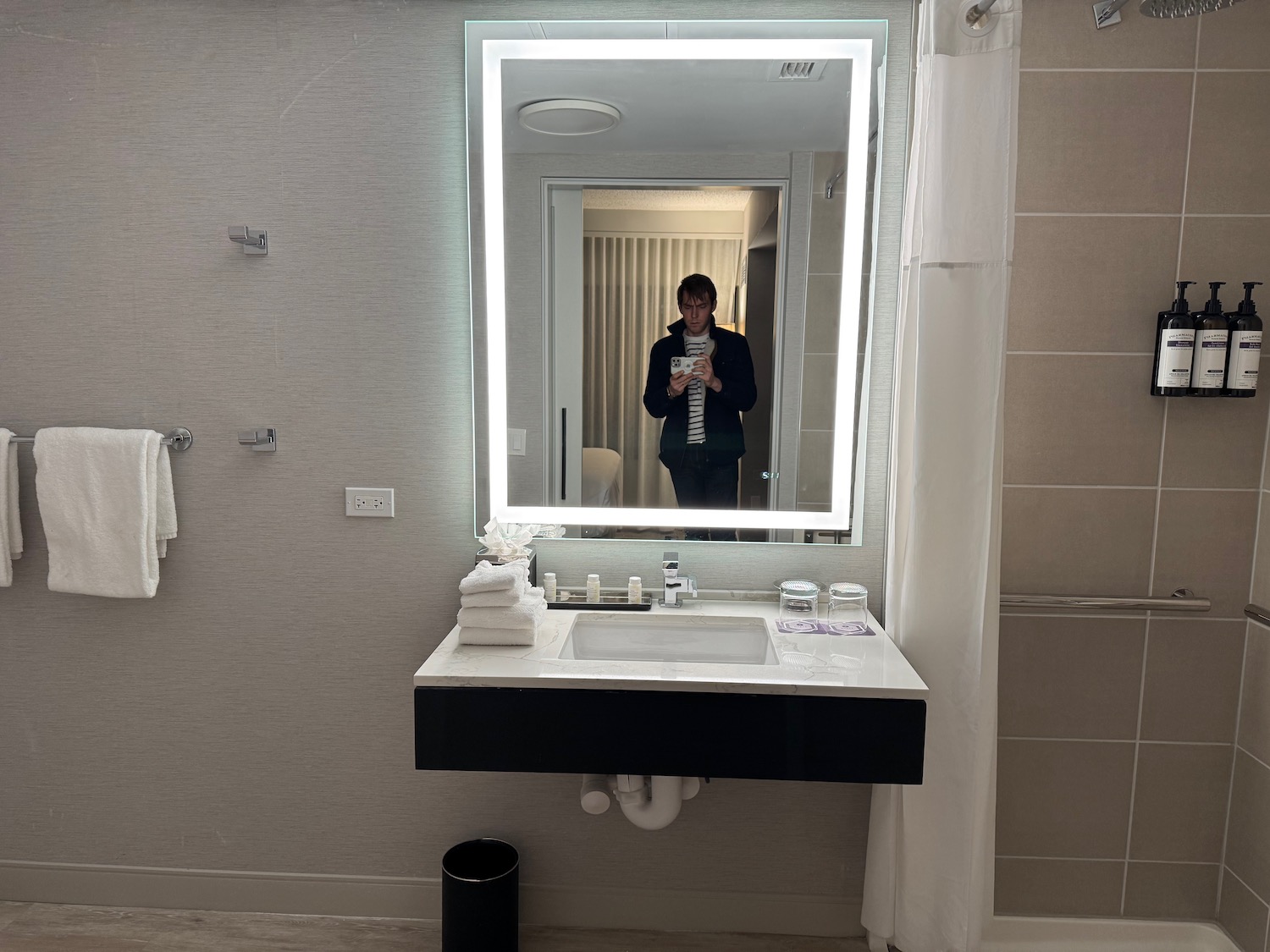 a person taking a selfie in a bathroom mirror