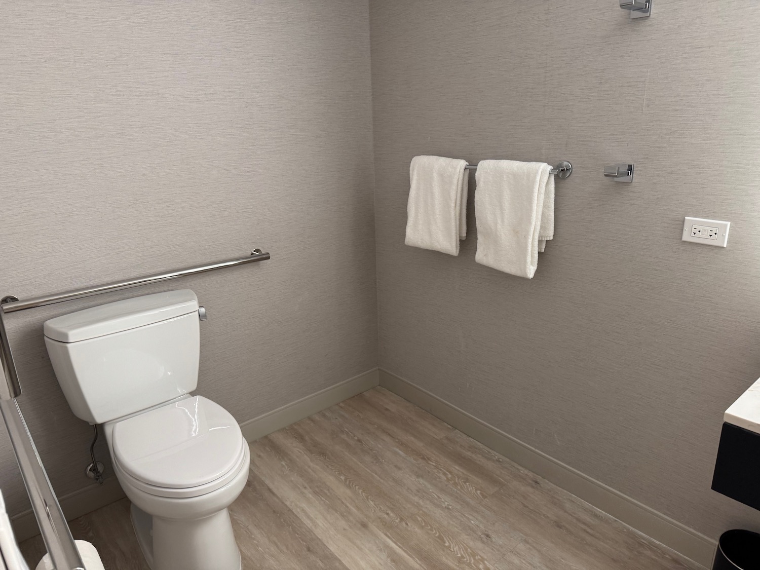 a bathroom with a toilet and towels