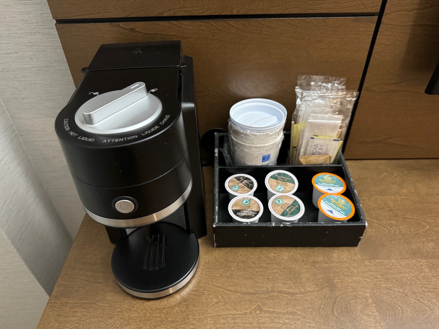 a coffee maker and coffee condiments