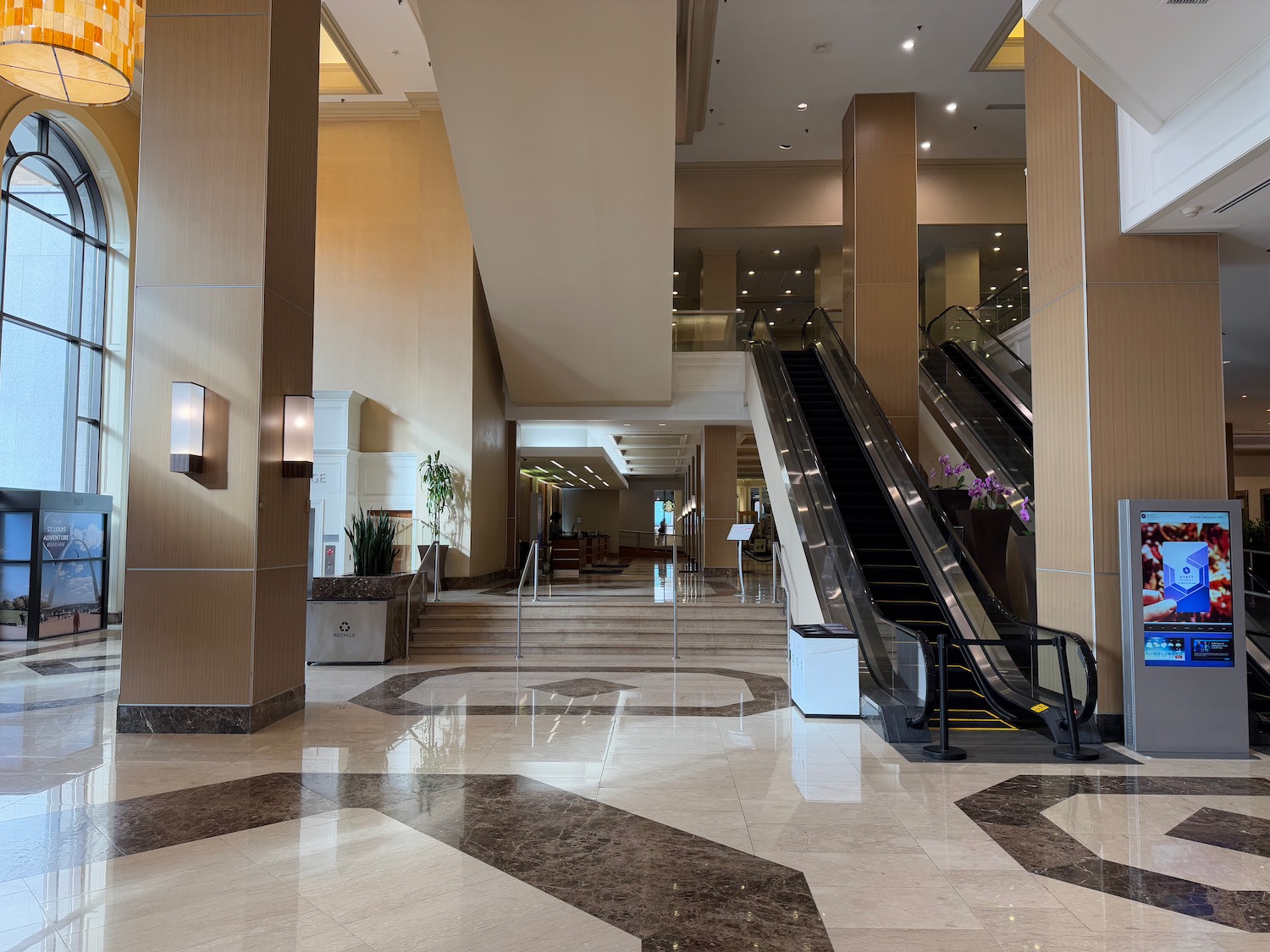 an empty lobby with an escalator