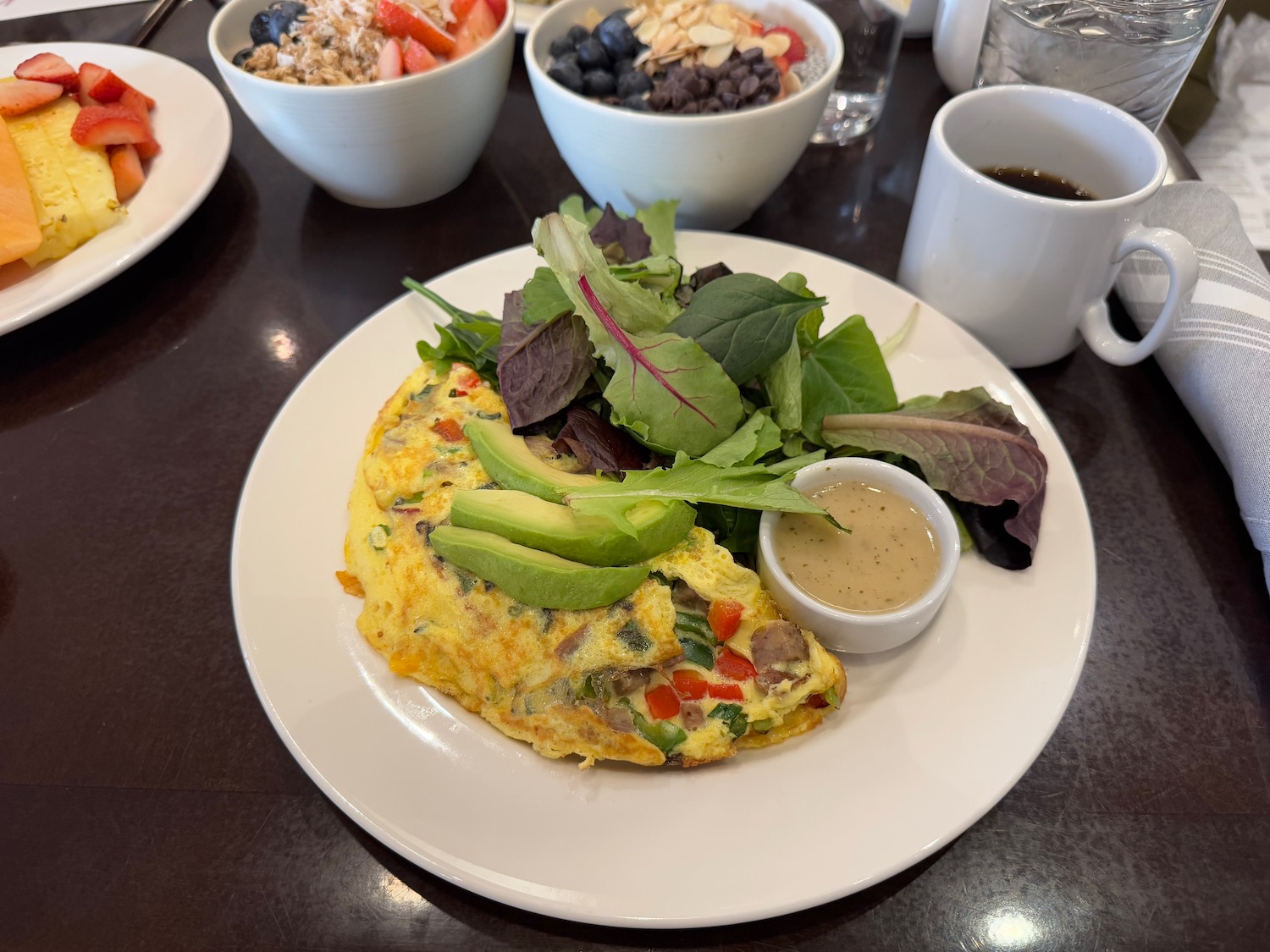 a plate of food with a side of salad and a cup of coffee