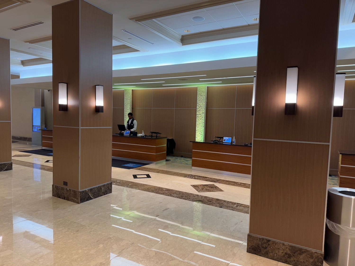 a hotel lobby with a man standing behind a desk