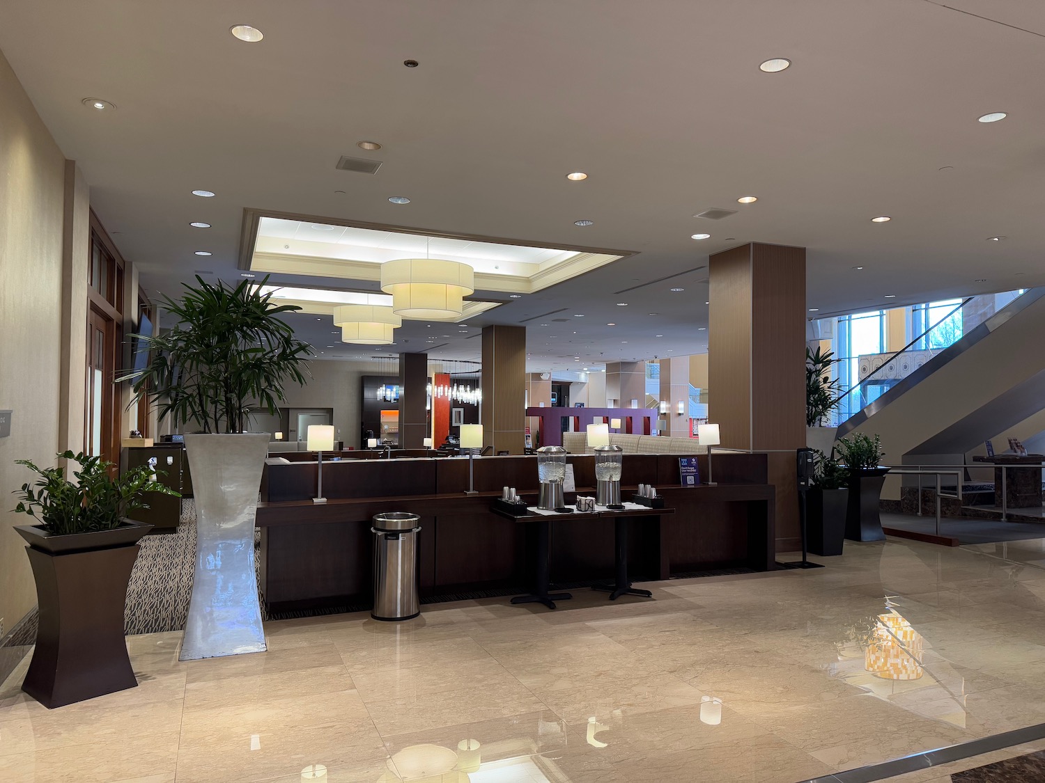 a lobby with a large counter and a planter