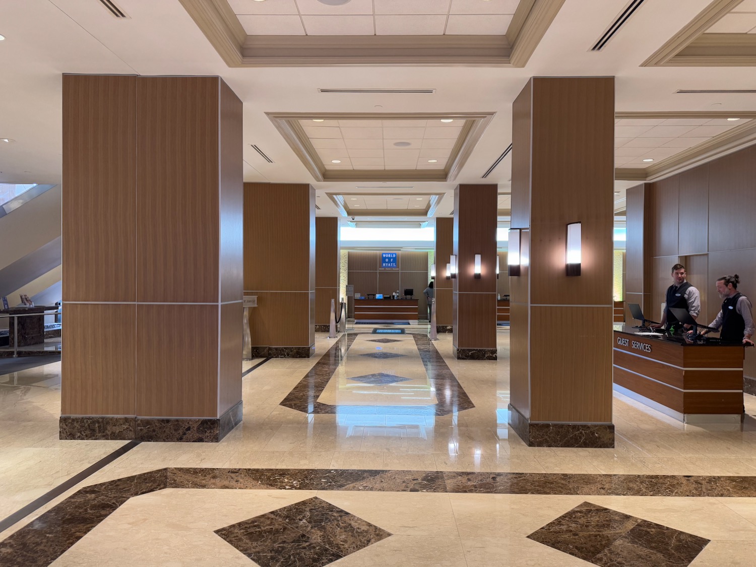 a lobby with columns and a check-in counter