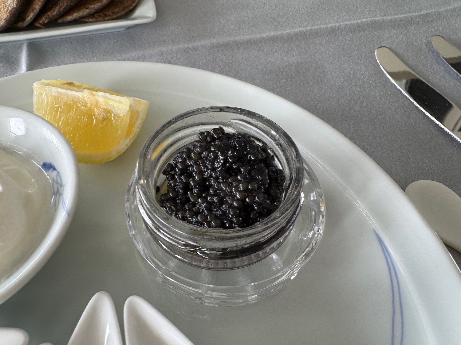 a bowl of black caviar on a plate