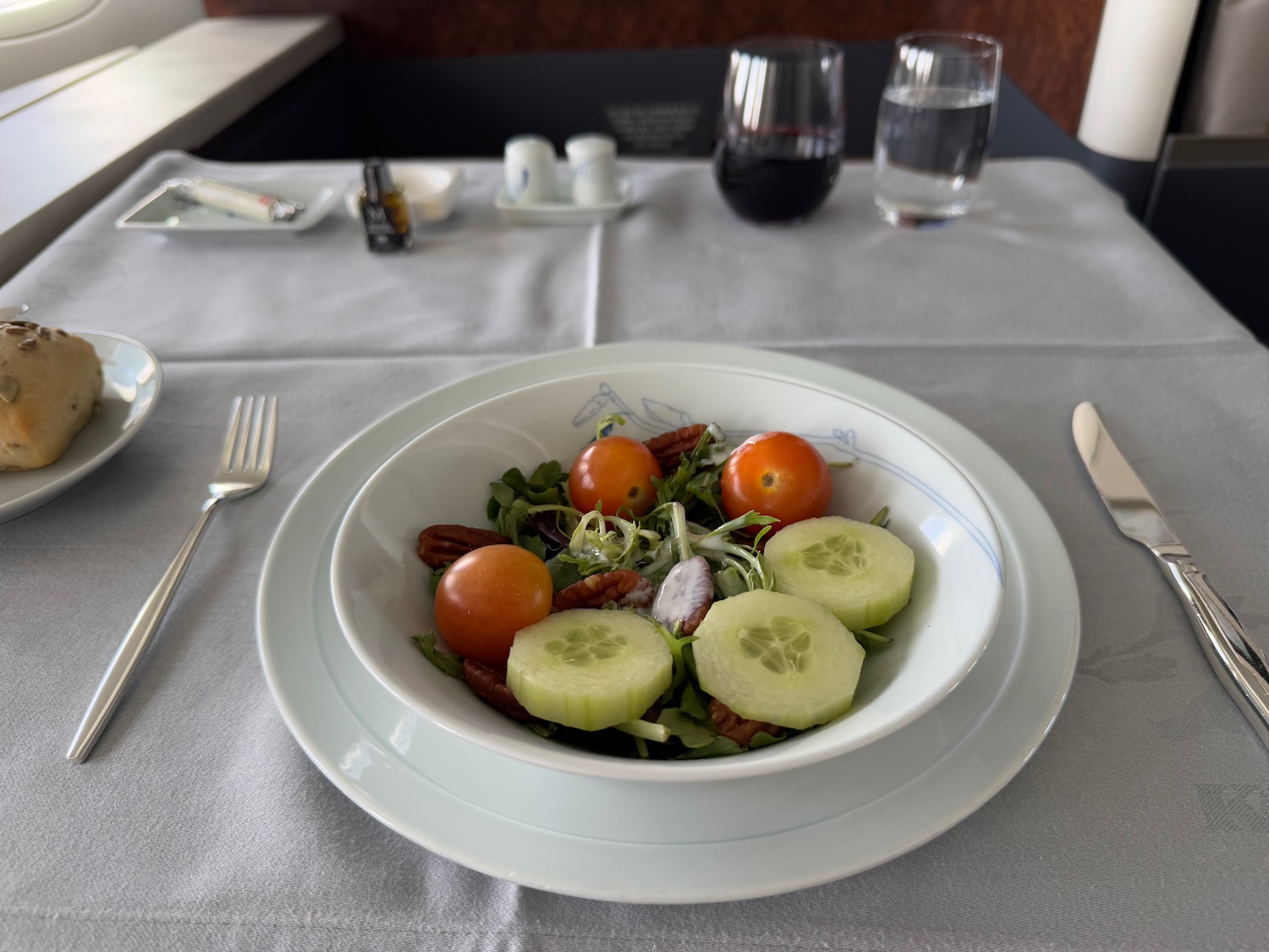 a plate of salad with cucumbers and tomatoes