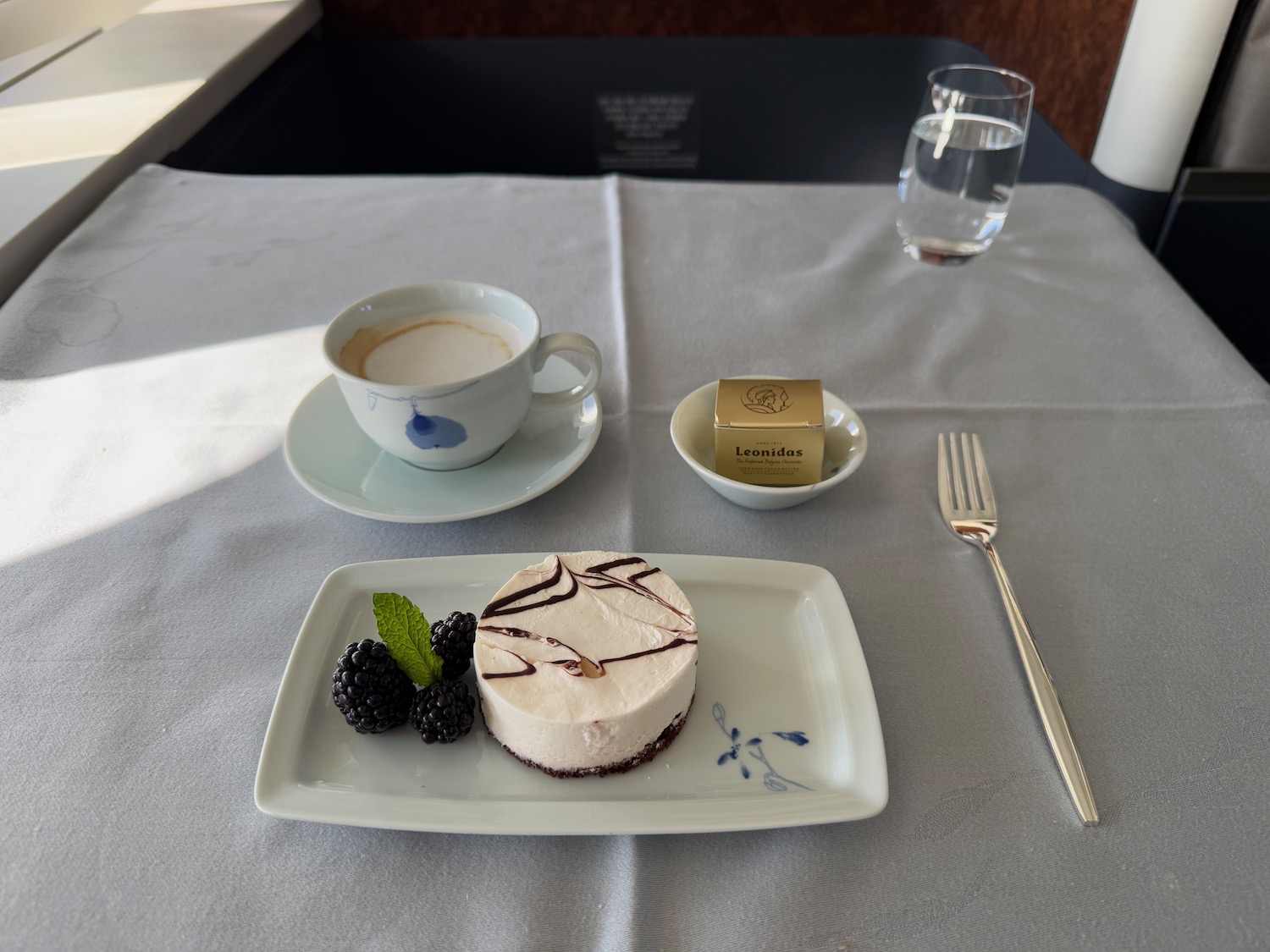 a plate of dessert and a cup of coffee on a table