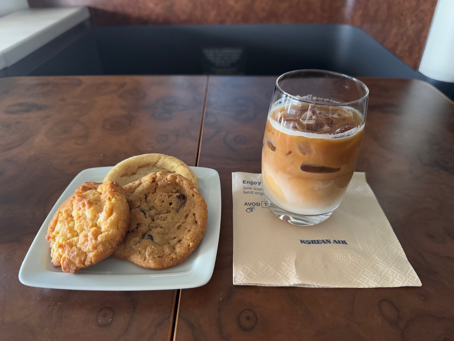 a plate of cookies and a glass of coffee on a table