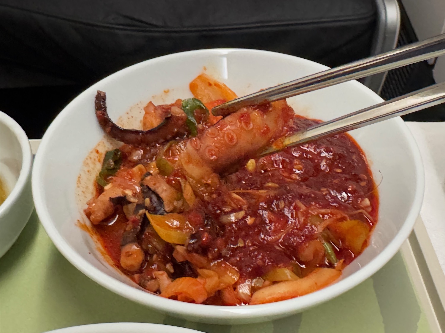 a bowl of food with chopsticks