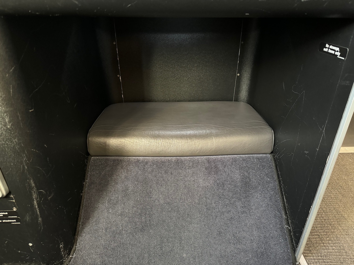 a grey carpeted floor in a black box