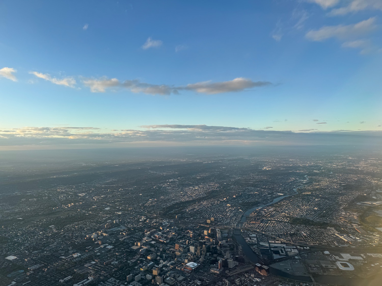 a city with a river and a blue sky