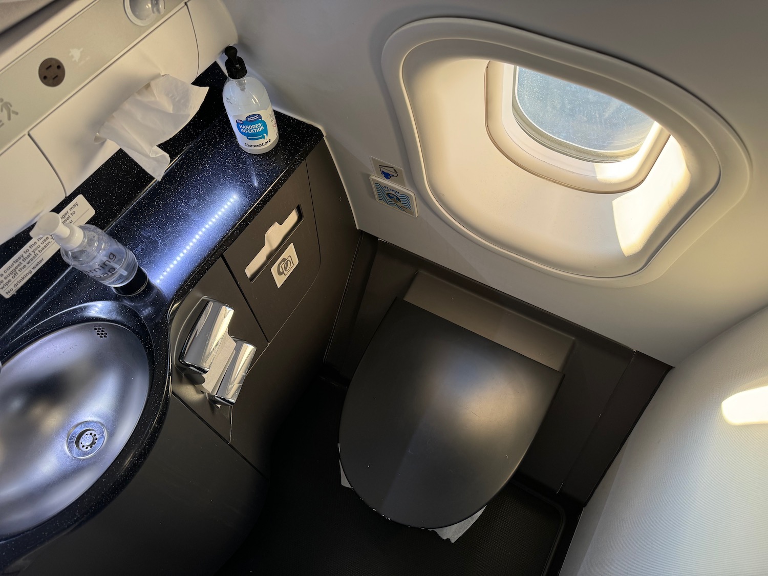 a toilet and sink in an airplane