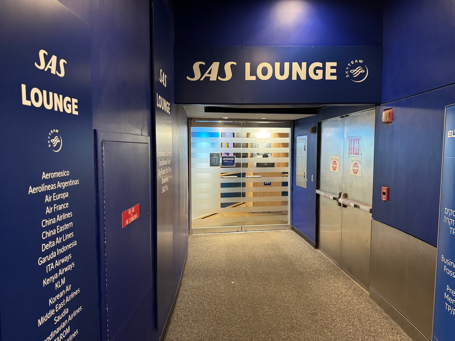 a blue and silver hallway with signs