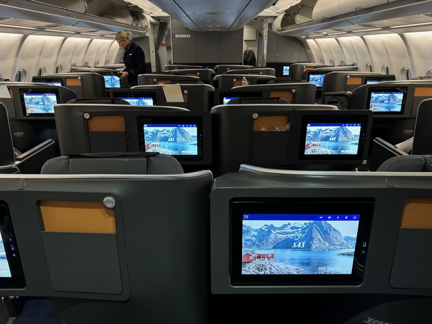 a row of seats with monitors on them