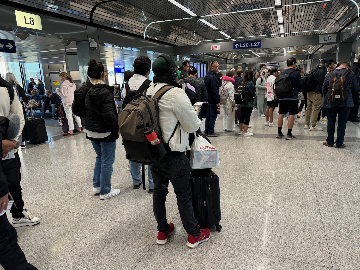 a group of people standing in a room with luggage