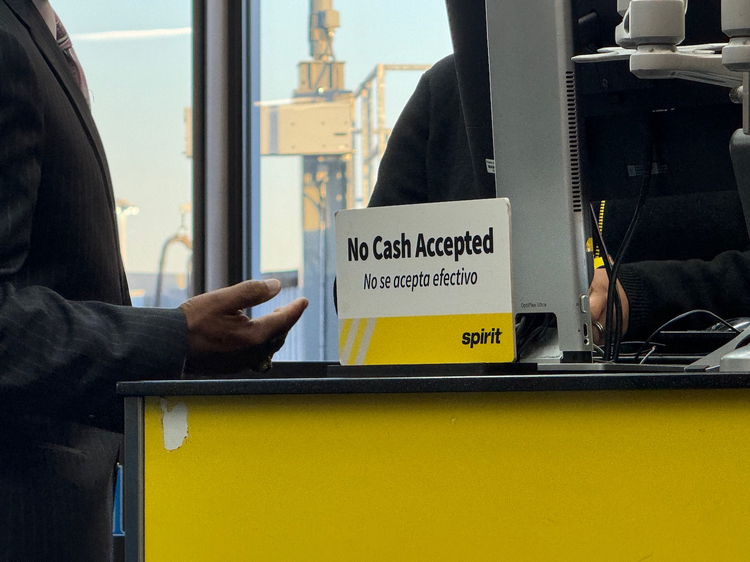 a man standing next to a sign