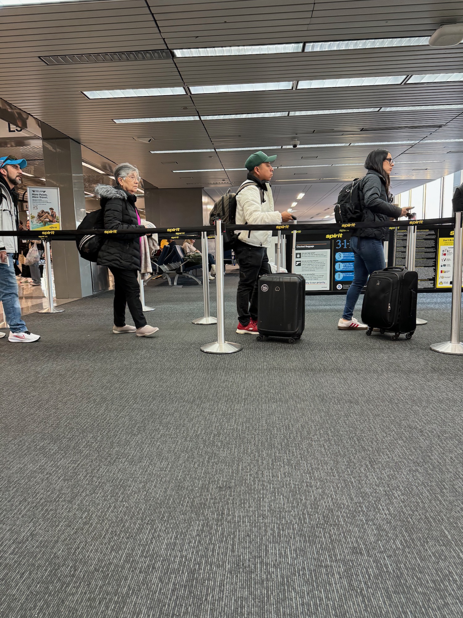 people standing in a line with luggage