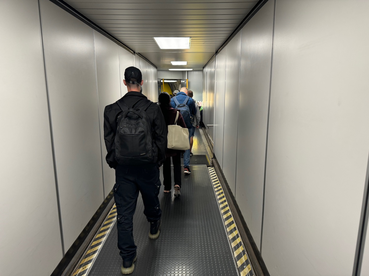 a group of people walking down a walkway