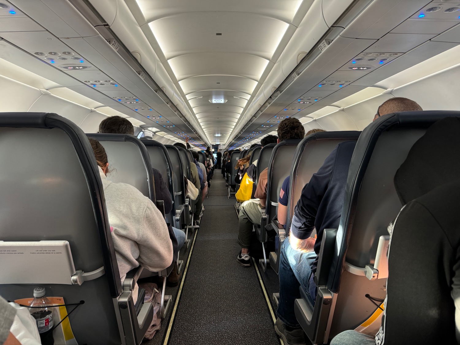 a group of people sitting in an airplane