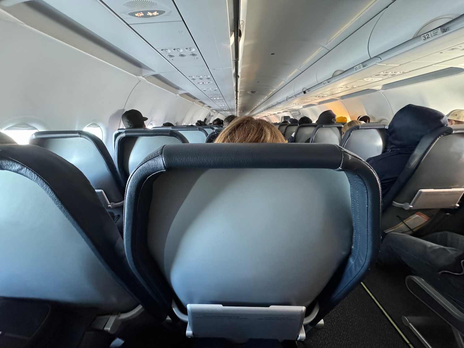 a plane with seats and people in the background