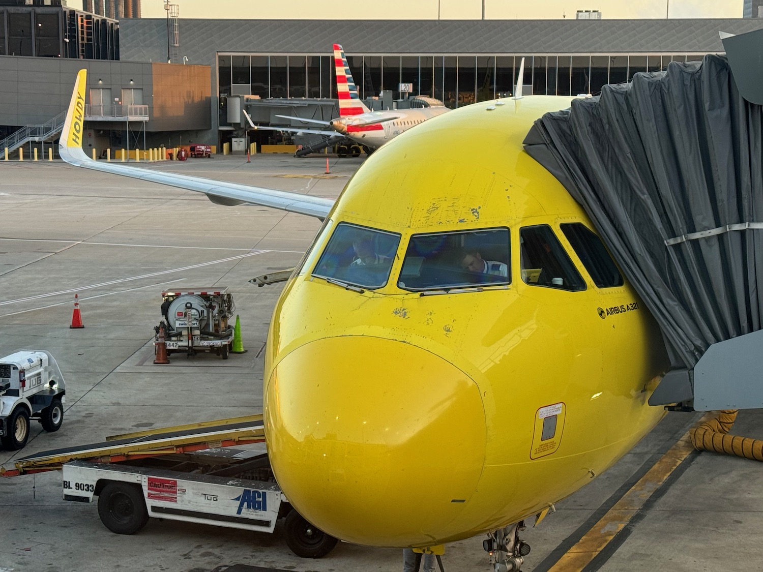 a yellow airplane with a black cover on the nose