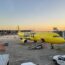 a yellow airplane on a tarmac