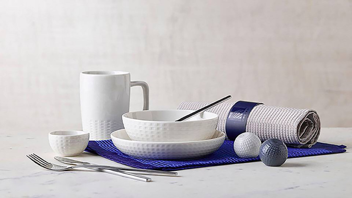 a table with a white tableware set