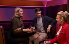 a group of people sitting in a booth