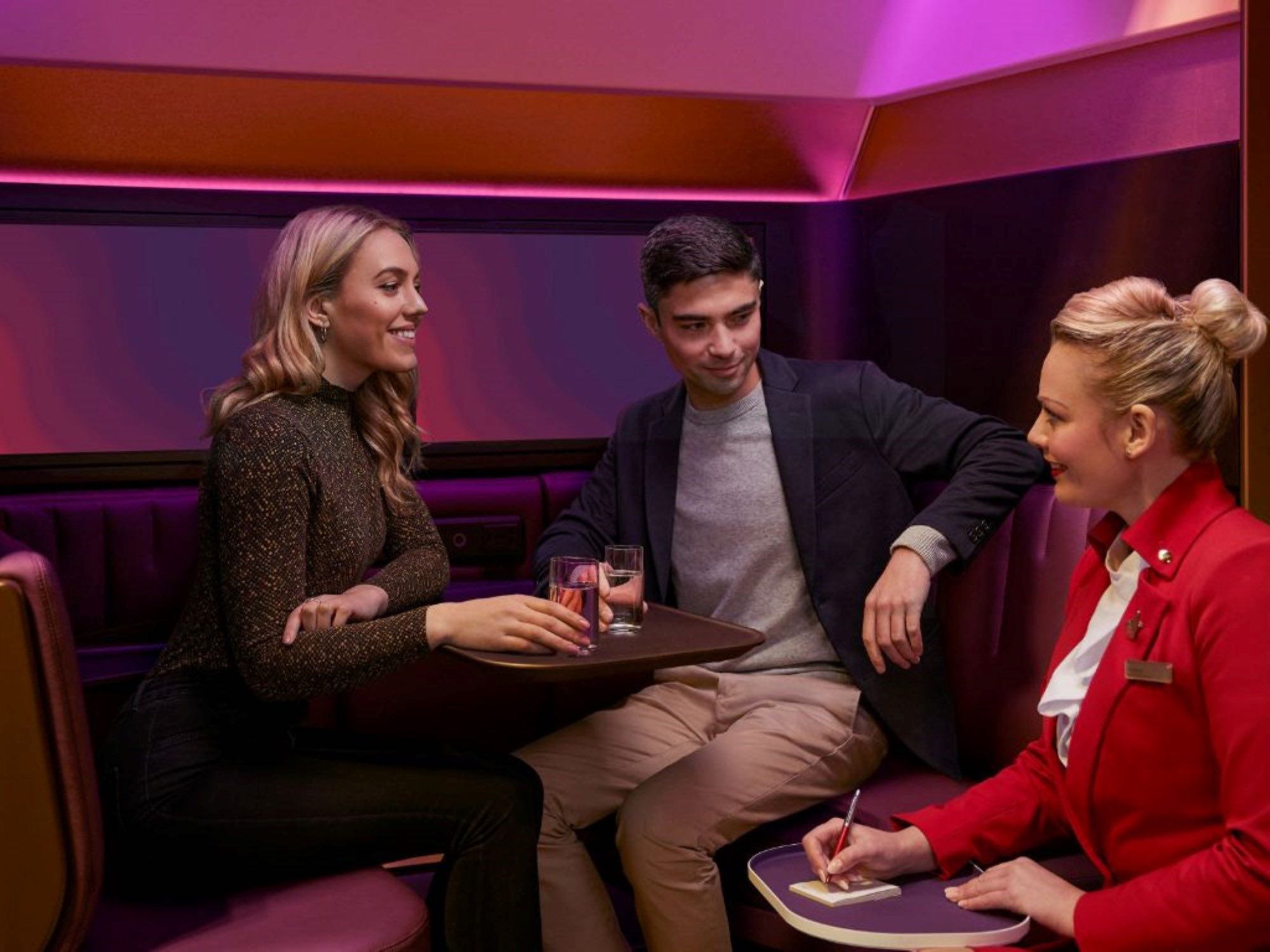 a group of people sitting in a booth