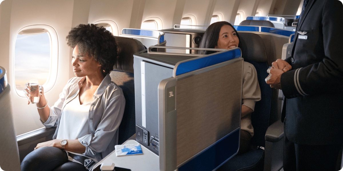 a group of women sitting on an airplane